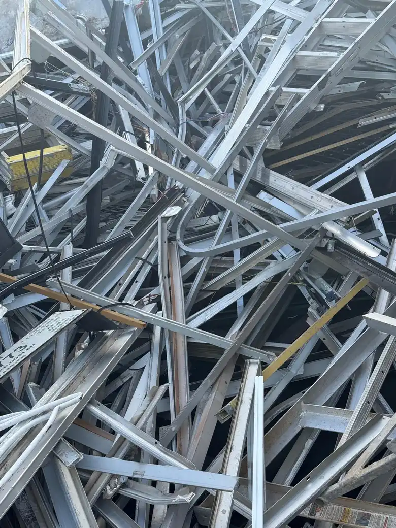 Workers weighing aluminium sheet and extrusion scrap on certified scale at Sydney recycling facility