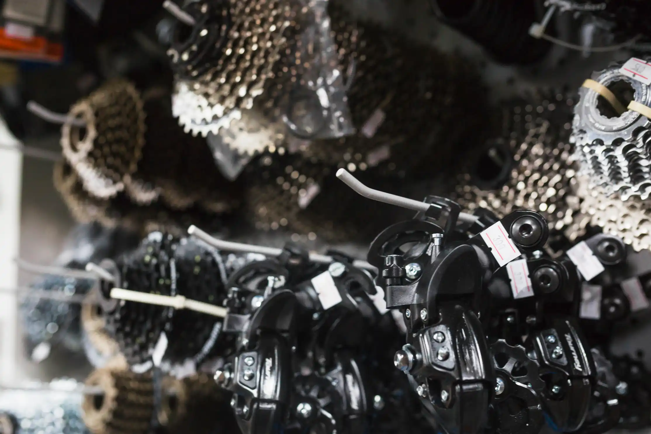 Close-up of used bicycle gears and derailleur parts stored in a workshop for scrap metal and catalytic converter recycling in Sydney